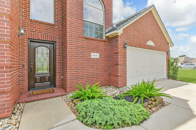 8006 Sports Haven Dr, Humble, TX 77346 - property entrance featuring driveway, brick siding, and an attached garage