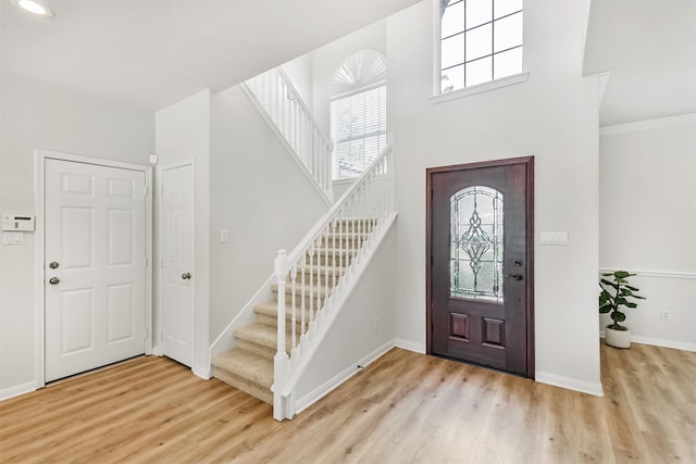 8006 Sports Haven Dr, Humble, TX 77346 - foyer entrance with light wood finished floors, stairs, and a towering ceiling