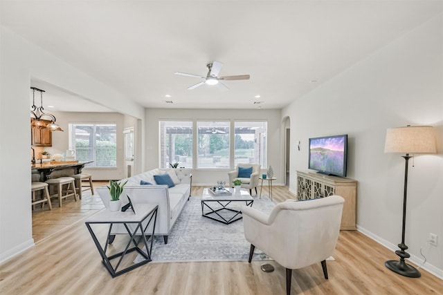 8006 Sports Haven Dr, Humble, TX 77346 - living area featuring light wood-type flooring, arched walkways, a ceiling fan, and recessed lighting