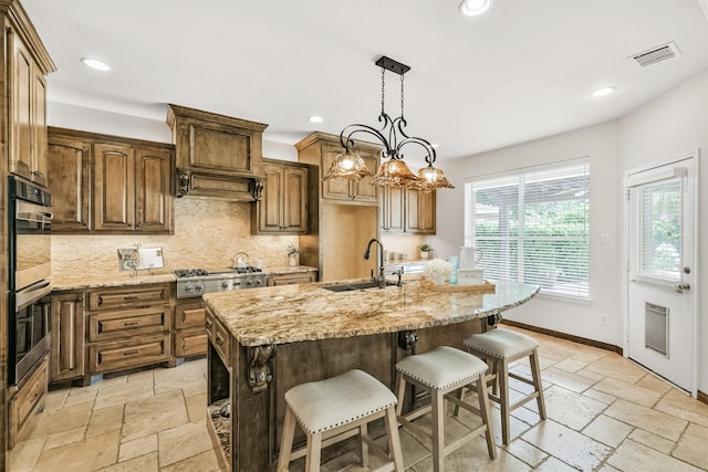 8006 Sports Haven Dr, Humble, TX 77346 - kitchen with tasteful backsplash, stone tile floors, appliances with stainless steel finishes, light stone counters, and recessed lighting