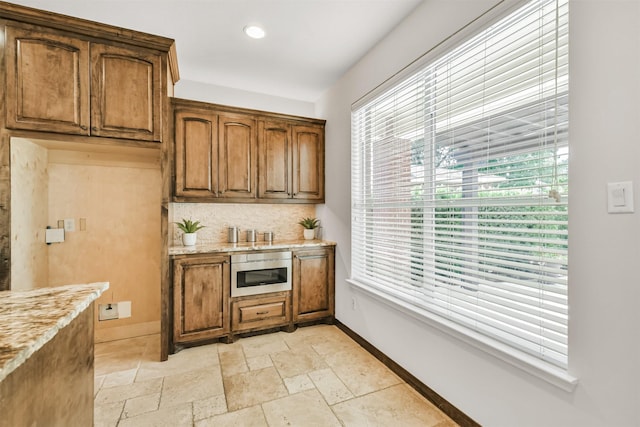 8006 Sports Haven Dr, Humble, TX 77346 - bar area featuring recessed lighting, stone tile floors, and backsplash