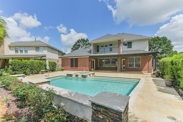 8006 Sports Haven Dr, Humble, TX 77346 - back of property featuring a balcony, brick siding, a patio, and a pool with connected hot tub