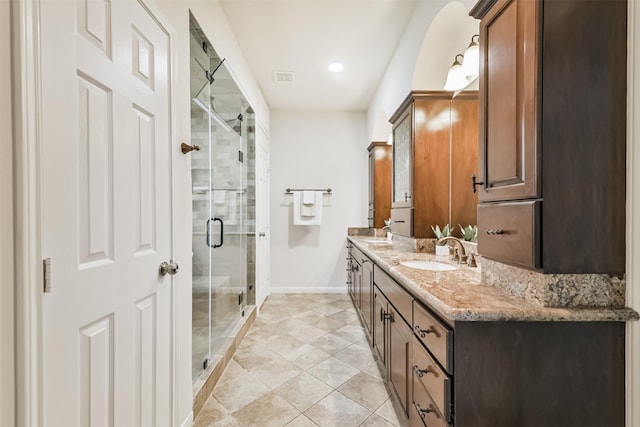 8006 Sports Haven Dr, Humble, TX 77346 - bathroom with double vanity, a shower stall, tile patterned floors, and recessed lighting
