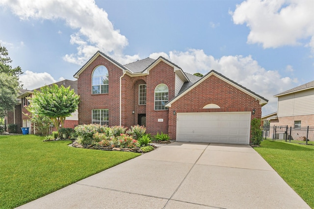 8006 Sports Haven Dr, Humble, TX 77346 - traditional home with brick siding, an attached garage, and driveway