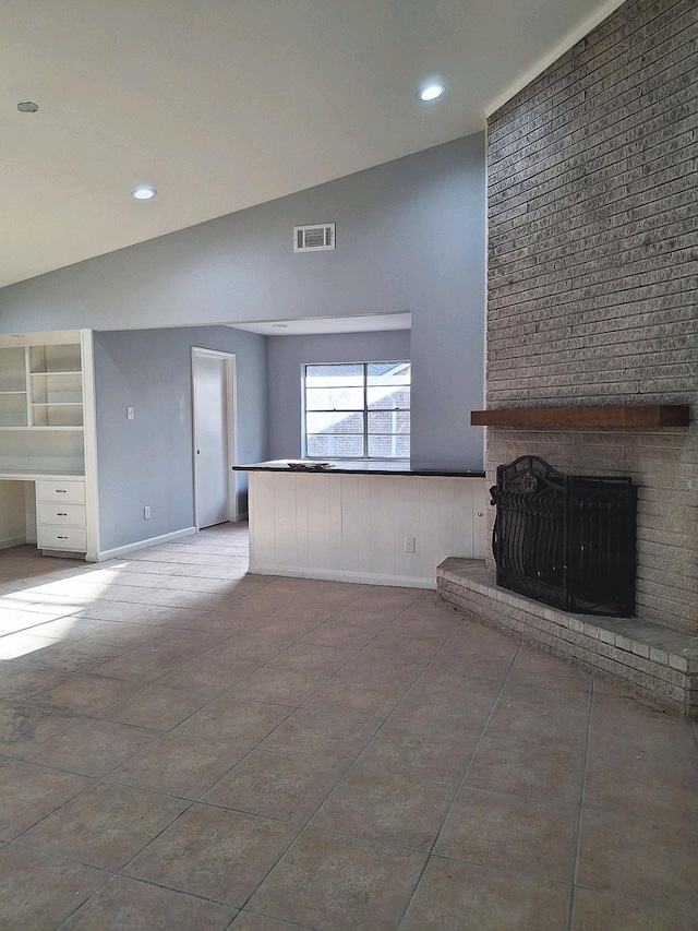 7807 Bellerive Dr, Houston, TX 77036 - unfurnished living room featuring a brick fireplace, a wainscoted wall, high vaulted ceiling, and recessed lighting