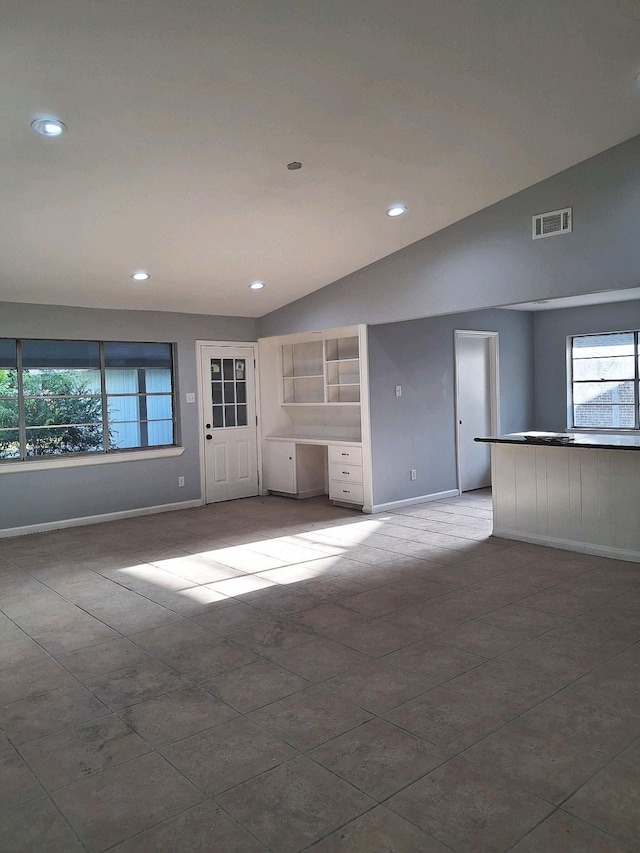 7807 Bellerive Dr, Houston, TX 77036 - unfurnished living room with plenty of natural light, vaulted ceiling, and recessed lighting