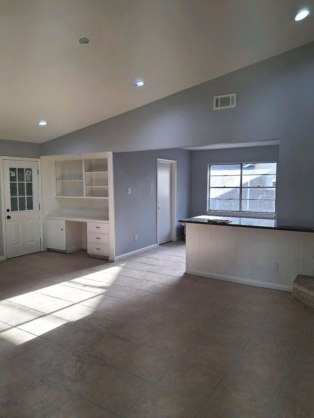 7807 Bellerive Dr, Houston, TX 77036 - tiled empty room with vaulted ceiling and recessed lighting