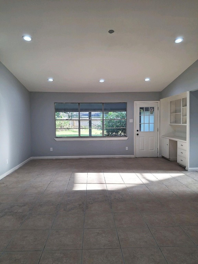 7807 Bellerive Dr, Houston, TX 77036 - tiled empty room featuring plenty of natural light and recessed lighting