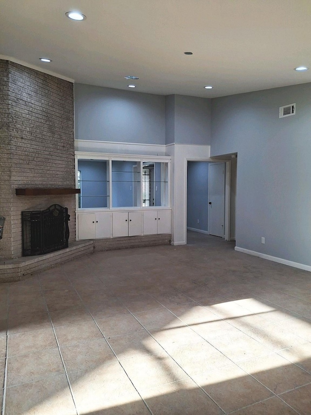 7807 Bellerive Dr, Houston, TX 77036 - unfurnished living room with recessed lighting, tile patterned flooring, and a brick fireplace