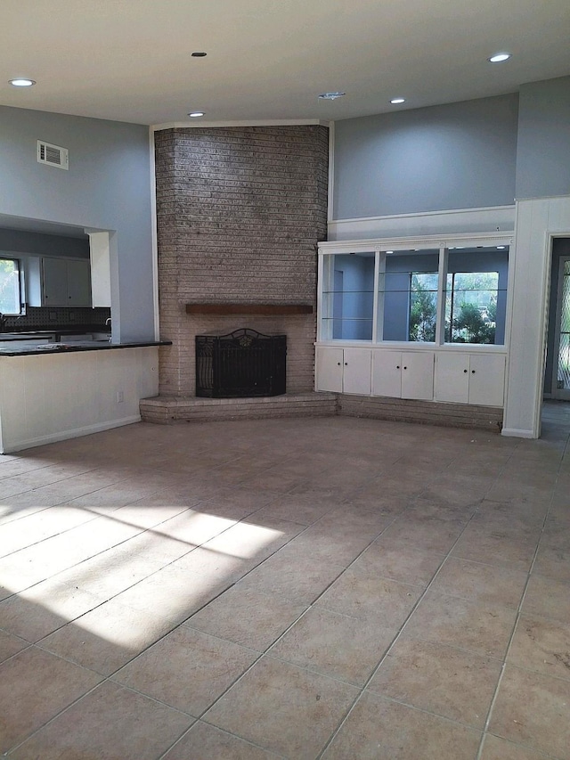 7807 Bellerive Dr, Houston, TX 77036 - unfurnished living room with a fireplace, recessed lighting, and tile patterned flooring