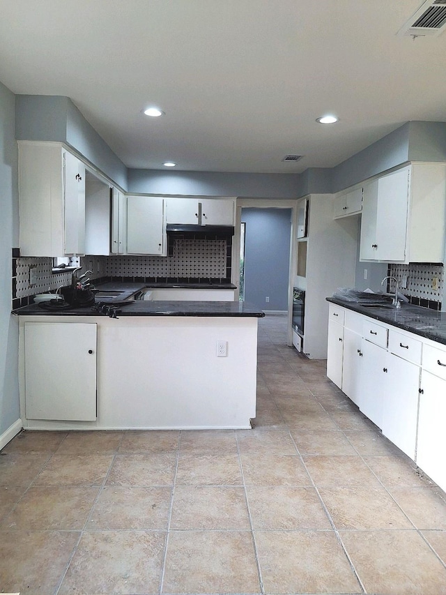 7807 Bellerive Dr, Houston, TX 77036 - kitchen with dark countertops, decorative backsplash, oven, and recessed lighting