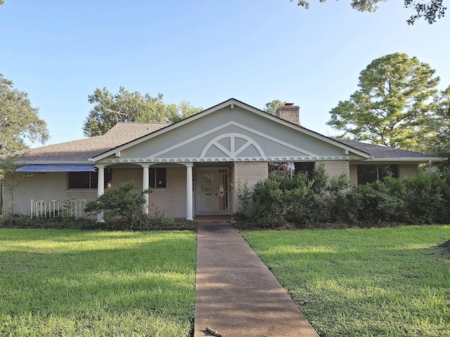7807 Bellerive Dr, Houston, TX 77036 - view of front facade featuring brick siding, a front lawn, a chimney, and a porch