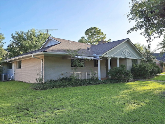 7807 Bellerive Dr, Houston, TX 77036 - view of front of property with brick siding, a front yard, a chimney, and roof with shingles