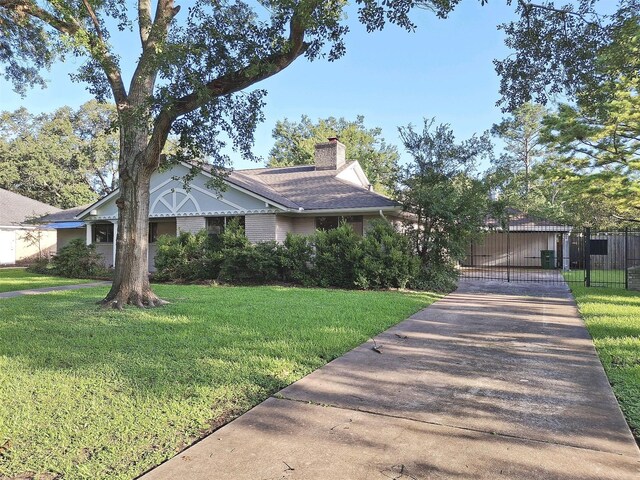 7807 Bellerive Dr, Houston, TX 77036 - view of front facade featuring a chimney, a gate, and concrete driveway