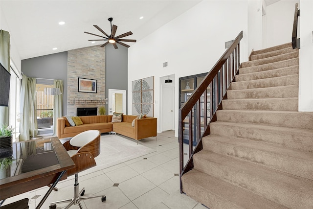 8727 Vinkins Rd, Houston, TX 77071 - living room featuring stairs, ceiling fan, high vaulted ceiling, a fireplace, and light tile patterned floors