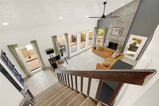 8727 Vinkins Rd, Houston, TX 77071 - staircase with lofted ceiling, tile patterned flooring, ceiling fan, recessed lighting, and a large fireplace