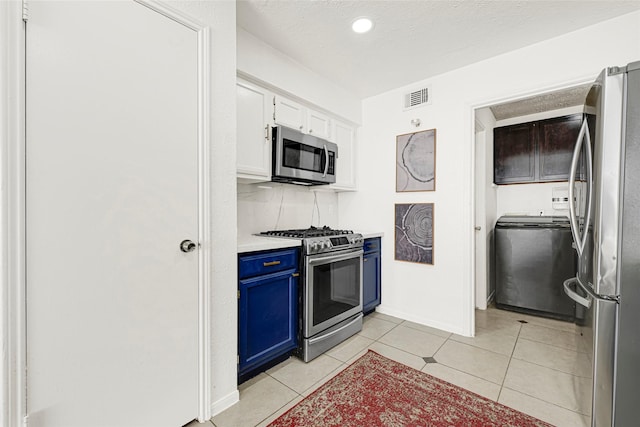 8727 Vinkins Rd, Houston, TX 77071 - kitchen featuring stainless steel appliances, blue cabinets, washer / clothes dryer, light countertops, and white cabinets