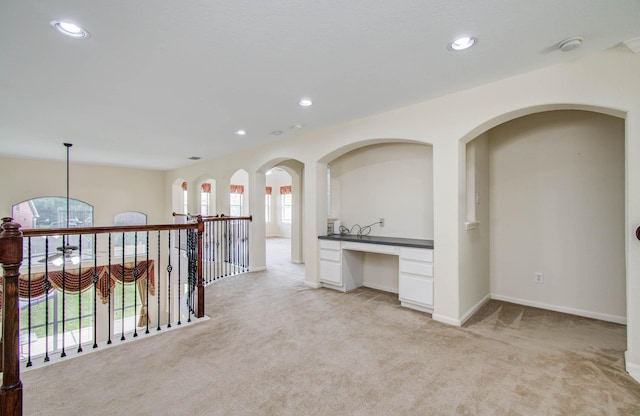 11704 Shoal Lndg, Pearland, TX 77584 - hallway featuring light colored carpet, a desk, and recessed lighting