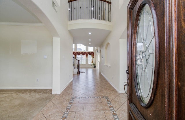 11704 Shoal Lndg, Pearland, TX 77584 - entryway featuring a high ceiling, arched walkways, recessed lighting, light tile patterned flooring, and stairs