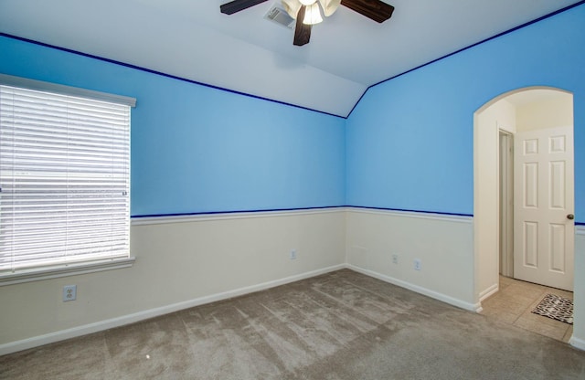 11704 Shoal Lndg, Pearland, TX 77584 - empty room featuring ceiling fan, vaulted ceiling, arched walkways, and carpet