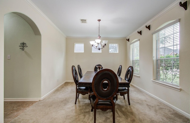 11704 Shoal Lndg, Pearland, TX 77584 - dining room featuring a chandelier, ornamental molding, and light colored carpet