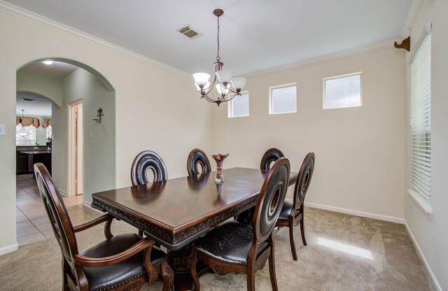 11704 Shoal Lndg, Pearland, TX 77584 - dining room with ornamental molding, a chandelier, light colored carpet, and arched walkways