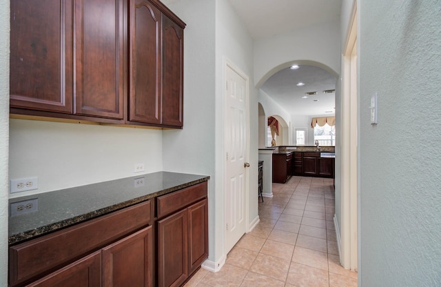 11704 Shoal Lndg, Pearland, TX 77584 - hallway featuring arched walkways, light tile patterned floors, and recessed lighting