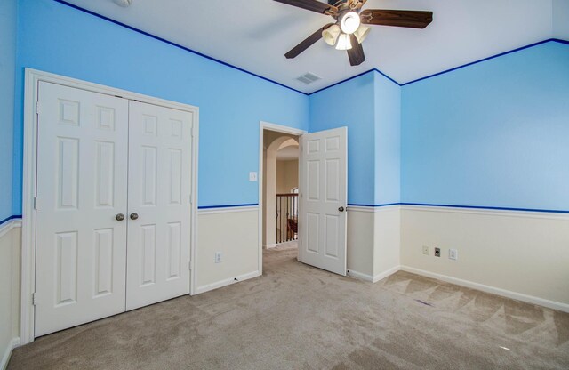 11704 Shoal Lndg, Pearland, TX 77584 - unfurnished bedroom featuring carpet flooring, a closet, arched walkways, and ceiling fan