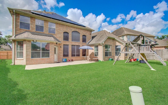 11704 Shoal Lndg, Pearland, TX 77584 - back of house featuring a playground, a patio area, solar panels, and brick siding