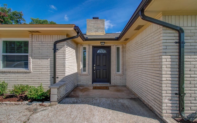 12407 Big Oaks Dr, Houston, TX 77050 - property entrance featuring a chimney and brick siding