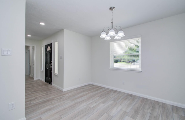 12407 Big Oaks Dr, Houston, TX 77050 - empty room with light wood finished floors, a chandelier, and recessed lighting
