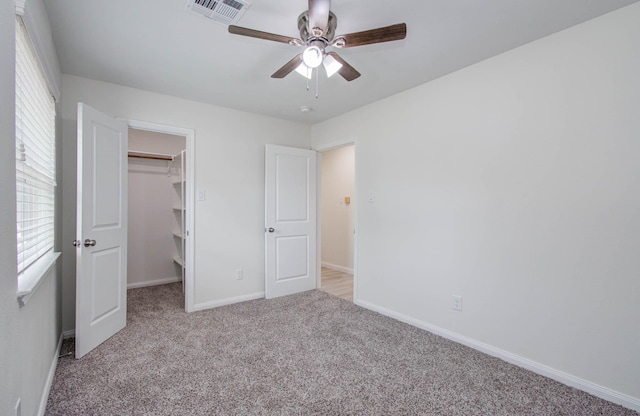 12407 Big Oaks Dr, Houston, TX 77050 - unfurnished bedroom with a spacious closet, carpet floors, multiple windows, and ceiling fan