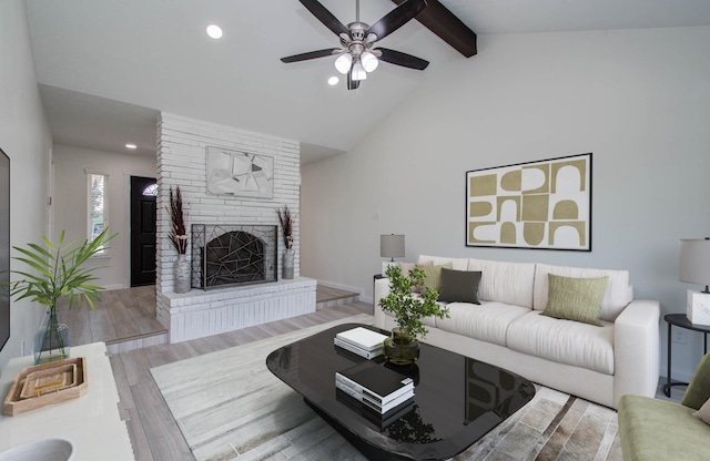 12407 Big Oaks Dr, Houston, TX 77050 - living room with ceiling fan, beamed ceiling, a brick fireplace, recessed lighting, and wood finished floors