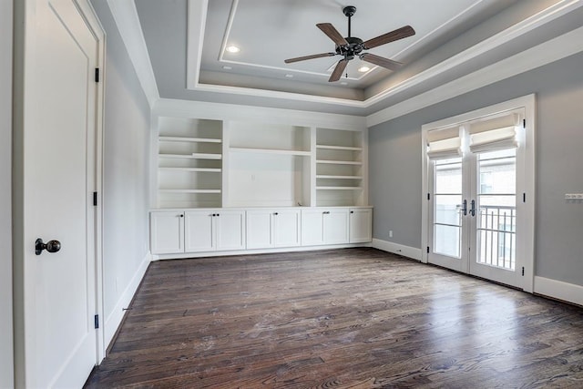 8015 Serenity Ct, Houston, TX 77025 - spare room with french doors, dark wood finished floors, a ceiling fan, a raised ceiling, and built in features
