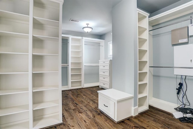8015 Serenity Ct, Houston, TX 77025 - walk in closet with dark wood-style floors