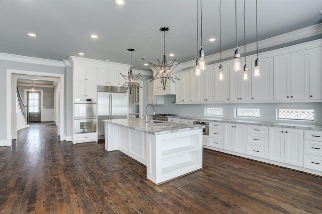 8015 Serenity Ct, Houston, TX 77025 - kitchen featuring crown molding, stainless steel appliances, a chandelier, white cabinetry, and tasteful backsplash