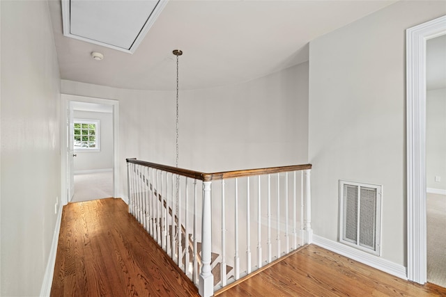 2105 Del Monte Dr, Houston, TX 77019 - hallway featuring an upstairs landing, attic access, and wood finished floors