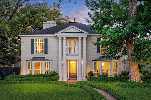 2105 Del Monte Dr, Houston, TX 77019 - neoclassical home with a chimney, brick siding, and roof with shingles