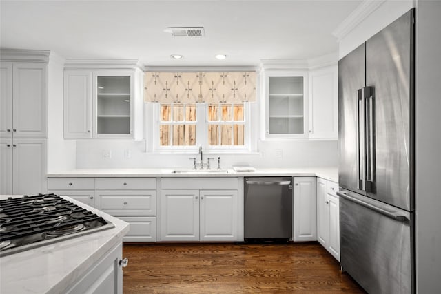 2105 Del Monte Dr, Houston, TX 77019 - kitchen with stainless steel appliances, white cabinets, decorative backsplash, dark wood finished floors, and glass insert cabinets