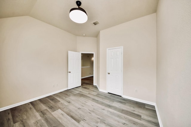 6902 Sterling Meadow Dr, Katy, TX 77449 - unfurnished bedroom featuring vaulted ceiling and wood finished floors