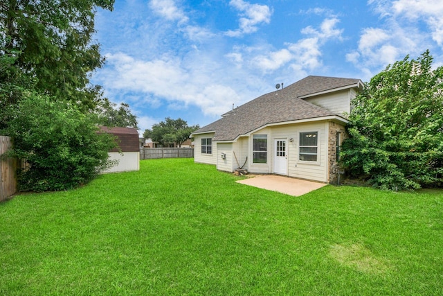 6902 Sterling Meadow Dr, Katy, TX 77449 - back of house with a shingled roof, a fenced backyard, a patio, and a shed