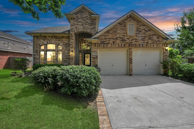 6902 Sterling Meadow Dr, Katy, TX 77449 - view of front facade with brick siding, driveway, an attached garage, and a yard