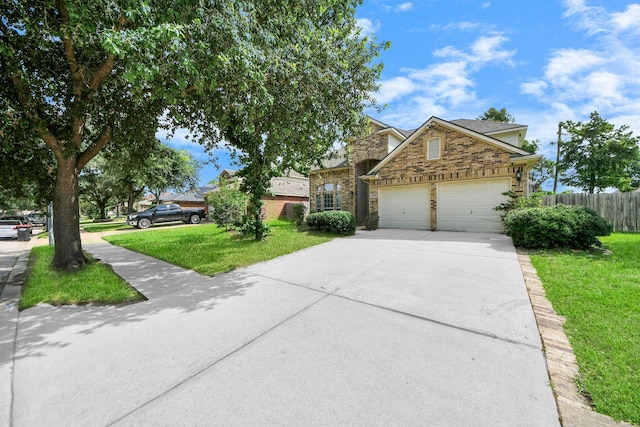6902 Sterling Meadow Dr, Katy, TX 77449 - view of front of house with stone siding, an attached garage, and driveway