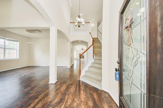 6902 Sterling Meadow Dr, Katy, TX 77449 - entryway with arched walkways, a chandelier, hardwood / wood-style floors, stairway, and a towering ceiling