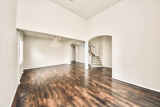 6902 Sterling Meadow Dr, Katy, TX 77449 - unfurnished room with arched walkways, wood finished floors, and stairs