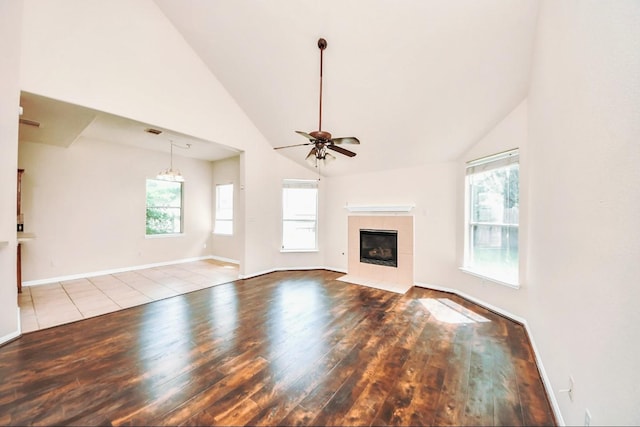 6902 Sterling Meadow Dr, Katy, TX 77449 - unfurnished living room with wood-type flooring, a ceiling fan, a fireplace, and high vaulted ceiling