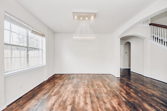 6902 Sterling Meadow Dr, Katy, TX 77449 - unfurnished dining area with wood finished floors, a chandelier, and arched walkways