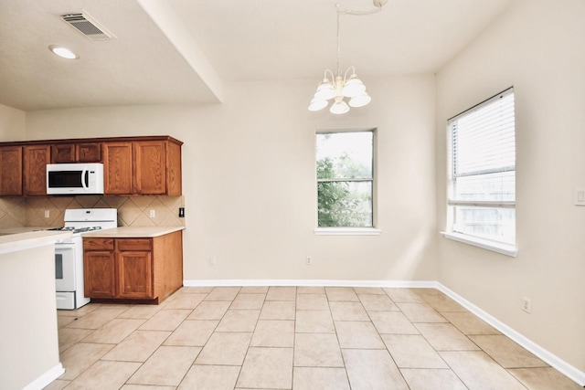 6902 Sterling Meadow Dr, Katy, TX 77449 - kitchen with white appliances, a chandelier, light countertops, backsplash, and brown cabinetry