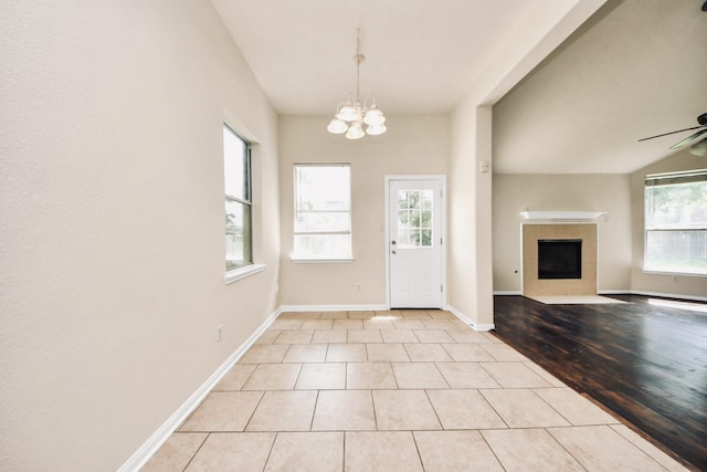 6902 Sterling Meadow Dr, Katy, TX 77449 - foyer entrance with a tile fireplace, plenty of natural light, a chandelier, and light tile patterned floors