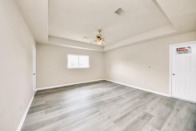 6902 Sterling Meadow Dr, Katy, TX 77449 - spare room with a raised ceiling, ceiling fan, and wood finished floors